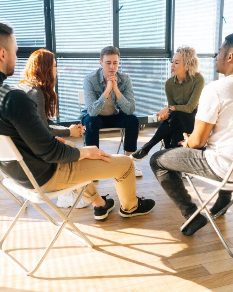 Multi-ethnic coworkers discussing working or personal issues-min